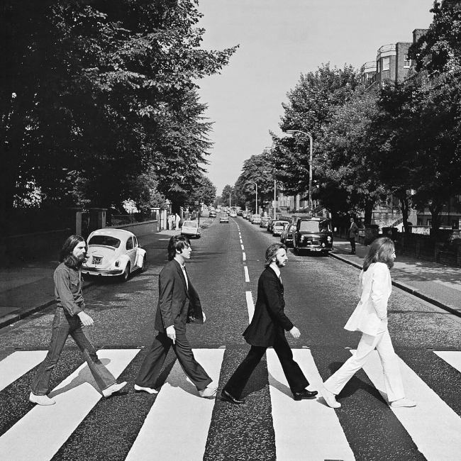 Front cover of Abbey Road by The Beatles. The view really is Abbey Road, London, NW8 looking north. The gates of the Abbey Road Studios are behind the white VW Beetle on the left.