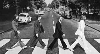 Front cover of Abbey Road by The Beatles. The view really is Abbey Road, London, NW8 looking north. The gates of the Abbey Road Studios are behind the white VW Beetle on the left.